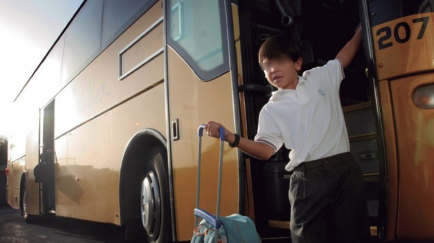 Un alumno baja del bus escolar