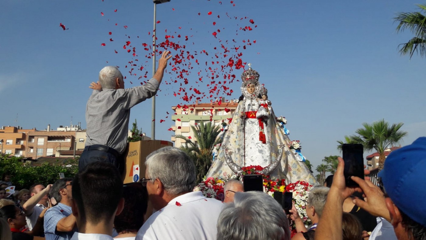 Los romeros lanzan pétalos al paso de la imagen de la Virgen