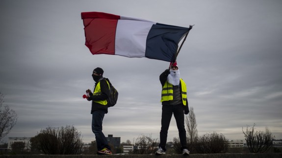 Chalecos amarillos enarbolan la bandera de Francia (foto: Miguel Osés / Europa Press)